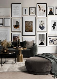 a living room filled with lots of framed pictures on the wall above a coffee table