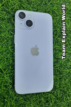 an iphone is laying in the grass with its camera lens on it's back