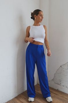 DETAILS: Our Lizzy High Waist Trousers In Blue have a high waisted fit and a wide legged fit. These bottoms have a waist pleated detail and two side pockets. The waistband has belt loops and for the closure there is a button, slide clasp, and zipper. CONTENT & CARE: SELF: 97% Polyester, 3% Spandex. SIZE & FIT: Model is 5'5" The model is wearing a size small. Fits true to size The Fabric has very little stretch Blue Pleated Pants Outfit, Bright Trousers Outfit, Bright Blue Pants Outfit, Royal Blue Pants Outfit Work, Cobalt Blue Pants Outfit, Blue Pants Outfit Work, Blue Pants Outfit Ideas, Bright Blue Outfit, Royal Blue Pants Outfit