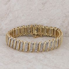 This ladies 10k yellow gold diamond bracelet has five hundred and eighteen diamonds in the entire 7.5". The diamonds weigh approx 1.29ctw and are SI2-I1 clarity and H-I color. It has a hidden box clasp and a safety chain. It weighs 16.24 grams.  Condition: Pre-owned *All items are thoroughly inspected for quality assurance purposes Yellow Gold Diamond Bracelet With Pavé Setting For Anniversary, Yellow Gold Diamond Bracelet With Pave Setting For Anniversary, Gold Diamond Bracelet For Anniversary, Anniversary Diamond Bracelet With Pave Setting, Classic Gold Diamond Bracelet With Diamond Accents, Gold Tennis Bracelet With Diamond Accents, Gold Diamond Tennis Bracelet With Pave Setting, Gold Tennis Bracelet With Diamond Accents For Anniversary, Anniversary Gold Tennis Bracelet With Diamond Accents