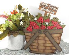 a basket filled with strawberries and flowers next to a sign that says farm fresh farmers