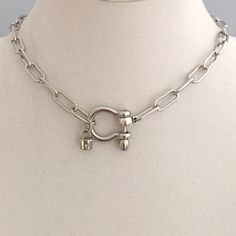 Carabiner Chain Necklace-Choker Necklace-Clasp Chain Necklace-Silver Cable Necklace-Silver Shackle Necklace-Shackle Jewelry-Padlock Charm  A beautiful shiny silver chain made up of paperclip links. The chain is brass and has several plating coatings of color to give the silver electroplated finish.   It is a high quality chain choker chain. The anchor shackle clasp gives the necklace a modern and unusual edge.  It is Silver Plated - Rhodium Plated. Size 21 x 25 mm  To finish off this neck shackle  I added a small CZ padlock with a CZ bail. The padlock also features a CZ star. If you look at the pictures you can see that the shackle clasp unscrews and the chain link is easily navigated both off and onto the shackle. This is a modern and versatile necklace.  Very much on trend. An added feat Silver Metal Necklace With Carabiner Clasp, Silver Necklace With Carabiner Clasp In Metal, Sterling Silver Toggle Necklace With Lobster Clasp, Sterling Silver Toggle Necklace With Lobster Clasp Chain Link, Silver Link Chain Necklace With Carabiner Clasp, Silver Chain Link Necklace With Toggle Clasp, Silver Chain Necklace With Toggle Clasp, Silver Toggle Necklace With Chain, Silver Link Jewelry With Carabiner Clasp