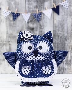 an owl is sitting on the ground next to some bunting