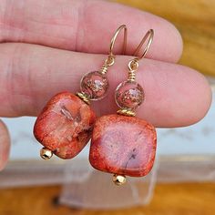 These dangle earring have an earthy vibe. Made with natural stone beads and Venetian glass beads; all in an orange-reddish color (very similar to the color of Carnelian Stone). Accented by gold-filled beads and and spacer. Wire wrapped and finished with gold-filled ear wires.  Price: $22.00 Earring length: 1 1/2 inches from the top of the ear wire to the bottom of the earring Your jewelry will arrive safely tucked into a complimentary gift box, ready to be gifted. Thank you for visiting my Etsy jewelry shop, please stop by again soon! Susan Red Agate Earrings With Natural Stones, Bohemian Glass Beaded Earrings Gift, Red Agate Earrings For Gift, Red Earrings With Natural Stones In Round Beads, Red Agate Earrings As Gift, Red Agate Dangle Earrings, Handmade Jasper Earrings As Gift, Bohemian Red Earrings With Natural Stones, Unique Red Earrings With Natural Stones