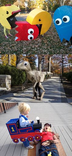 two children sitting on a bench in front of some paper animals