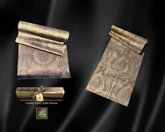 an image of some gold items on a black background, including a roll of paper and a pair of scissors