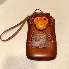 Leather Handmade Monkey Wristlet/Phone Case Perfect For Smaller Essentials In Cognac. Special-Tanned Cowhide. 3d Leather Produce Techniques. Genuine Leather Handmade Unisex Wristlet Phone Carrier Zipper And Magnetic Closure Perfect For Your Smaller Essentials Removable Wristband New Unused; No Flaws I Honor Poshmark’s Return Policy. I Do My Best To Clearly Represent My Items. Shop With Confidence! 5 Rated Posh Ambassador, Fast Shipping From A Clean Smoke Free, Pet Free Home! I Welcome All Questi Brown Leather Pouch Phone Bag, Brown Leather Rectangular Phone Bag, Brown Pouch Wallet With Mobile Phone Bag, Portable Leather Phone Bag Pouch, Orange Pouch Wallet For Daily Use, Orange Rectangular Coin Purse For Daily Use, Brown Handheld Phone Bag, Handheld Brown Pouch For Daily Use, Orange Pouch Wallet For Everyday Use