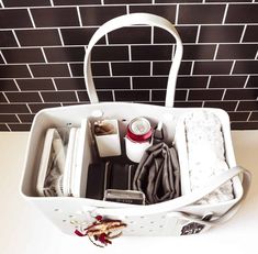 a white purse with many items in it