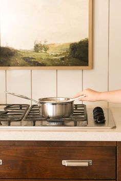 a woman is cooking on the stove top