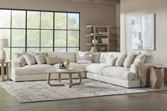 a living room filled with furniture and a large window in the wall above it's windowsill