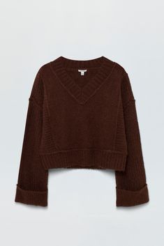 Textured, medium weight pullover sweater. Designed for boxy, relaxed silhouette with oversized cuffed sleeves, cropped length hem, and wide V open neckline. Oversized ribbing details at neckline, cuffs, and hem. Offered in a dark brown hue. 64% Acrylic / 13% Polyester / 9% Nylon / 8% Alpaca / 4% Wool / 2% Spandex Dark Brown Clothes, Brown Sweaters, Dark Sweater, Thanksgiving Sweater, Witchy Aesthetic, Best Swimwear, Boxy Sweater, Denim Sweater, Corset Crop Top