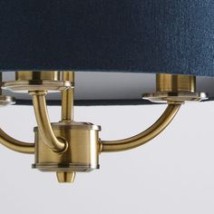 a close up of a light fixture with a blue shade