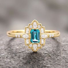 Step into the elegance of a bygone era with our Natural London Blue Topaz Ring, beautifully set in 14K yellow gold vermeil. This exquisite engagement ring draws inspiration from the opulent Art Deco period, blending vintage charm with timeless sophistication.►The centerpiece is a stunning London blue topaz, renowned for its deep, captivating hue that evokes the mysterious beauty of twilight skies. The intricate detailing of the band, adorned with delicate filigree patterns and sparkling accents, Luxury Art Deco Topaz Ring With Diamond, Luxury Classic Topaz Ring With Intricate Design, Luxury Topaz Ring With Intricate Design For Formal Events, Mysterious Beauty, London Blue Topaz Ring, Bygone Era, Art Deco Period, Art Deco Engagement Ring, London Blue Topaz