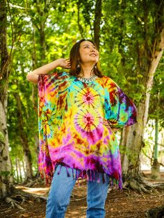 Indulge in the unique charm of our hand-dyed tunic top, meticulously crafted for those who appreciate exceptional fashion. Made from 100% breathable and comfy rayon, this stunning piece is designed to elevate your style while ensuring absolute comfort. Our tunic top stands out with its one-of-a-kind hand-dyed method, guaranteeing that no two pieces are exactly alike. Embracing a loose silhouette, it offers a versatile fit that flatters a wide range of sizes, from S to 2XL. With its side-stitched closure and convenient armholes, this slipover style tunic top is incredibly easy to wear. A delightful feature of this blouse is the fringes decoration adorning the bottom, adding a touch of bohemian elegance to your ensemble. The tunic top measures up to 60" in the bust and hip, providing ample r Cheap Bohemian Tie-dye Tops, Kaftan Blouse, Bohemian Tie Dye Summer Cover-up, Flowy Multicolor Tunic Cover-up, Bohemian Hand-dyed Tie-dye Tops, Flowy Tie-dye Tunic Kaftan, Side Stitch, Poncho Tops, Tie Dye Outfits