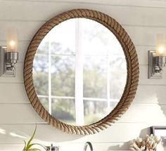 a round mirror hanging on the side of a wall