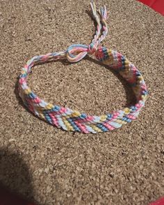 a multicolored rope bracelet sitting on top of a table