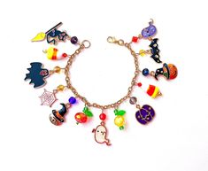 This happy and colorful Halloween charm bracelet is handcrafted by myself, and contains an assortment of enamel charms.  The gold plated chain is 7 3/4 inches long with 13 charms containing  jack o lanterns, ghosts,  bat, cats, and candy corn.  If you need it shorter or longer just let me know, and I will adjust it to as close as possible to the size you desire. If you would like a charm switched to something else just ask!  Each charm is placed with thought  for color and balance.  It is  a rea Novelty Multicolor Charm Bracelet, Multicolor Themed Jewelry With Charms, Themed Multicolor Jewelry With Charms, Customized Multicolor Novelty Jewelry, Customized Multicolor Themed Jewelry, Halloween Gift Charm Bracelet, Multicolor Themed Charm Bracelet As Gift, Handmade Multicolor Bracelets For Halloween, Halloween Novelty Jewelry With Charms