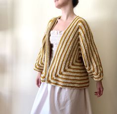 Long Sleeve Cotton Shrug For Fall, Bohemian Long Sleeve Cropped Sweater For Fall, Bohemian Long Sleeve Cropped Sweater For Spring, Beige Long Sleeve Winter Shrug, Chic Long Sleeve Fall Shrug, Chic Long Sleeve Shrug For Fall, Bohemian Yellow Sweater For Fall, Yellow Bohemian Sweater For Fall, Fitted Yellow Cardigan For Fall