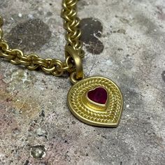 A unique take on a classic design, this pendant features a heart-shaped ruby framed by braids of gold. A very special gift for someone who holds your heart! Please note that pendants are sold separately from chains. 20K Peach Gold Heart-shaped ruby, 1.10 cwt Style Number: PP62BRHEART Hand fabricated in our New York City design atelier & workshop Traditional Heart-shaped Yellow Gold Jewelry, Gold Ruby Heart Pendant Jewelry, Yellow Gold Ruby Heart Pendant Necklace, Traditional Yellow Gold Jewelry For Valentine's Day, Ruby Heart Charm Pendant Necklace, Traditional Heart Charm Jewelry For Valentine's Day, Traditional Gold Jewelry With Heart Charm, Traditional Pendant Necklace For Valentine's Day, Traditional Valentine's Day Pendant Necklace