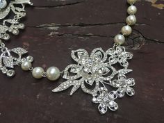 "Perfect for all bridal or party to wear!! Romantic shaped necklace featuring sparkle flower pendants and linked with pearl chains. Color: clear rhinestone crystals with pearls Size: necklace measures around 19.5\" long and large flower pendants around 6\" long x 3.25\" width Item ship out with tracking number to you (around 10 to 14 business days for delivery). We also provide fast shipping service, around 3-4 business days delivery but need to add extra charge. Please convo us if need." Wedding Crystal Necklace With Flower Design, Wedding Crystal Flower Necklace, Flower Crystal Wedding Necklace, Pearl Flower Necklace For Wedding, Wedding Pearl Drop Flower Pendant Necklaces, Wedding Pearl Drop Flower Pendant Necklace, Silver Pearl Wedding Necklace With Flower Pendant, Silver Flower Pearl Necklace For Wedding, Necklace Prom