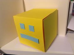 an origami box with a smiley face on it