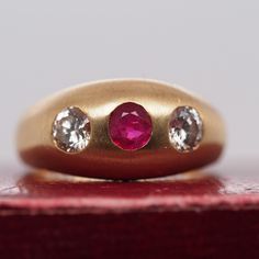 Item Details: Ring Size: 9.75 Metal Type: 14k White Gold [Hallmarked, and Tested] Weight: 9.6 grams Center Ruby Details: Red, Natural, .60ct, Round Diamond Details: .50ct each, K Color, VS Clarity, Transitional Round Band Width: 4.5mm Condition: Excellent Price: $2750 This ring can be sized up or down 4 sizes for an additional $40. If you wish to have a ring sized please purchase the item and note the size in the message section. Payment & Refund Details: More Pictures Available on Request Payment via Visa/Mastercard/Discover/AmericanExpress, check, money order or PayPal. Layaway * We will be more than happy to provide layaway payments for your convenience to make it easier to have the opportunity to enjoy one of our collection's treasure! Please contact us in advance so we can work out a Vintage Yellow Gold Signet Ring With Gemstone, Vintage Signet Ring With Brilliant Cut, Classic Three Stone Round Ruby Ring, Vintage Oval Signet Ring With Brilliant Cut, Vintage Brilliant Cut Signet Ring, Antique Yellow Gold Ruby Ring With Brilliant Cut, Vintage Signet Ring For Anniversary With Round Cut, Antique Style Brilliant Cut Yellow Gold Ruby Ring, Classic Three-stone Ruby Ring For Formal Occasions