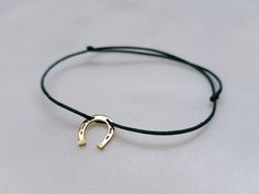 Hand made minimal bracelet. 925 sterling silver or 14k solid gold (material depends on you) Horseshoe shaped pendant on durable silk cord with sliding knot clasp. It's comfortable and adjustable. The bracelet size fits all wrists, but please message me if you need individual lenght, I'm happy to make it for you! Cord color of your choice, depending on stock availablility, search the selection picture. Adjustable Gold Horseshoe Jewelry, Silk Cord Jewelry, Sliding Knot Bracelet, Sparkly Bracelets, Minimal Bracelet, Pendant Minimalist, Horseshoe Pendant, Rose Gold Beads, Cord Jewelry