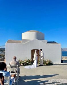 a couple getting married in front of an ocean view