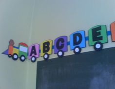 a blackboard with the word alphabet spelled out in colorful train shapes