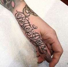 a person with a tattoo on their hand