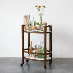 a bar cart filled with liquor bottles and flowers