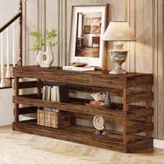 a wooden shelf with books and vases on it in front of a stair case