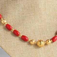 Elegant Gold Dangling Beads, Coral Necklaces With Gold Beads For Gifts, Traditional Gold Necklaces With Red Coral, Gold Beaded Necklaces With Red Coral, Gold Necklace With Large Red Coral Beads, Gold Necklace With Polished Red Coral Beads, Red Coral Necklace With Gold Beads For Gift, Festive Gold Beaded Colorful Necklaces, Festive Gold Necklace With Colorful Beads