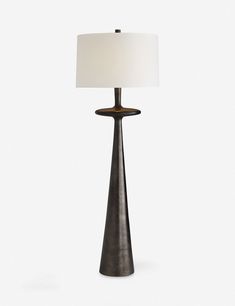 a table lamp with a white shade on it's base and a black stand