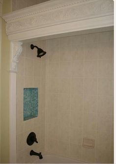 a bathroom with a tub, shower head and hand held faucet in it