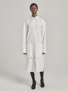 UNI FORM’s founder Luke Radloff designs timeless wardrobe staples you’ll want to wear for years to come. A shirt style that looks just as chic as a dress as it will as a light coat, this versatile number has an oversized fit with dropped shoulders, a storm flap-style overlay, and practical pockets. It’s been locally made in South Africa from pure cotton. Wear it with chunky sandals and silver jewelry. - Classic collar, concealed button fastening, long sleeves with extended cuffs, storm flap, poc African Luxury, Jewelry Classic, Timeless Wardrobe, Timeless Wardrobe Staples, Light Coat, Chunky Sandals, A Storm, Dresses Xs, White Cotton