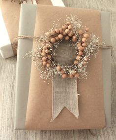 a present wrapped in brown paper with a wreath on it