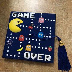 a game over graduation cap with pacman characters on it