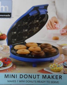 an advertisement for a donut maker with doughnuts in the tray and sprinkles on the table