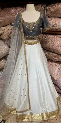 Jasmine white plain lehenga with gold border teamed with contrasting grey intricate in kundan, cut dana and stone work blouse and net dupatta. Fabric: Silk Occasion: Wedding Ceremony or Reception. WASH CARE INSTRUCTIONS - Please Dry clean only when it is applicable. Slight color variation is possible due to digital photography. This outfit can be customized in multiple colors and specific to client measurements. 120 days of production time is required and are for bulk orders only!Order are proce White Dola Silk Lehenga For Designer Wear, Designer White Dola Silk Lehenga, Designer White Lehenga With Sheer Dupatta, White Raw Silk Choli For Wedding, Festive White Choli With Sheer Dupatta, White Raw Silk Floor-length Lehenga, White Floor-length Raw Silk Lehenga, White Dola Silk Lehenga With Sheer Dupatta, White Dola Silk Lehenga For Festive Occasions