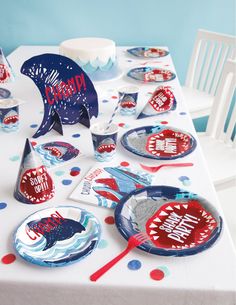 a table set up with plates, cups and napkins for a patriotic birthday party