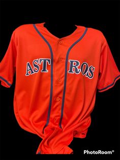 an orange baseball jersey with the word astros on it