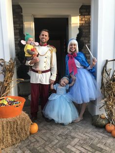 a man and woman in costumes standing next to a child