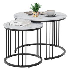 two tables with marble top and metal legs, one has a plant on the table