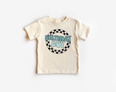 a white t - shirt with the words, birthday boy on it and checkered design