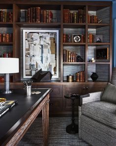 a living room filled with furniture and bookshelves covered in lots of bookcases