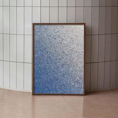 there is a blue and white tile wall next to a mirror on the floor in front of a tiled wall