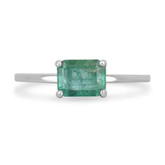 This solitaire emerald ring showcases a stunning emerald cut emerald, set horizontally east to west in a timeless four-prong setting. The ring is expertly crafted in sterling silver, lending a modern touch to the classic design. With its captivating emerald and minimalist style, this ring is perfect for adding a touch of elegance to any look. Setting Style: Prong-Solitaire  Setting Material: Sterling Silver  Main Stone: Emerald Shape: Emerald Cut  Weight: 1.05-Carats Clarity: Semi-Transparent  Color: Lush Green  Luster: Good Treatments: Natural, Oiling Origin: Zambia  Estimated Retail Value: $1,600.00 USD A certificate of appraisal is provided upon purchase. Keep in mind we custom create all of the items listed here. If you have a special request for a custom-created item please contact us Emerald Ring Design, Emerald Set, Emerald Gem, Tiny Bow, Solitaire Setting, Minimalist Gifts, Sterling Silver Engagement Rings, Emerald Earrings, Semi Transparent