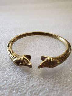 This listing is for an Antique Brass Bangle made in India with double snake heads. It fits comfortably on your wrist and is solid brass, so it is heavy. The engravings are very detailed on both sides of the bangle. There is no marking but on future research I learned they are made in India and are very old. It's very exotic and unique I would stack the bracelet with colored beaded bracelets. I purchased this at an estate sale last summer. It will arrive in a gift box with FREE SHIPPING. Fits up Vintage Gold Hand Cast Cuff Bracelet, Adjustable Antique Finish Jewelry Bracelet, Adjustable Antique Finish Bracelet, Engraved Bronze Brass Bangle, Ceremonial Engraved Brass Cuff Bracelet, Adjustable Engraved Brass Bangle, Bronze Engraved Brass Bracelets, Adjustable Medieval Bangle Cuff Bracelet, Antique Gold Brass Bracelet