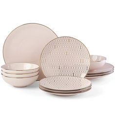 an assortment of white and gold dinnerware set on a white background with no one around it